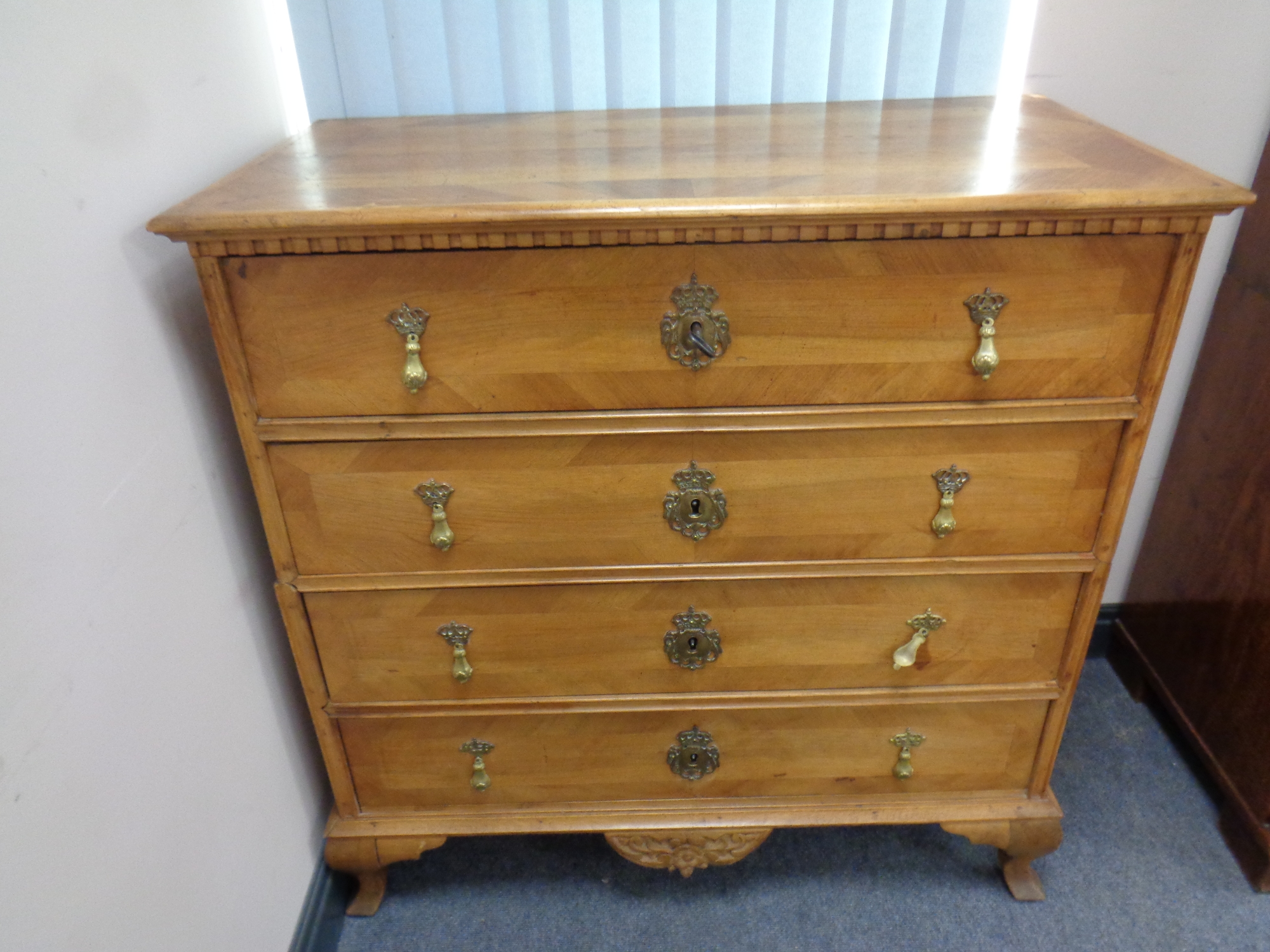 A late 19th century walnut four drawer chest,