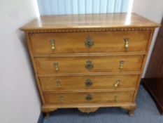 A late 19th century walnut four drawer chest,