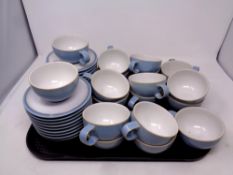 A tray containing eighteen Denby Colonial Blue teacups and saucers