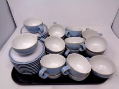 A tray containing eighteen Denby Colonial Blue teacups and saucers