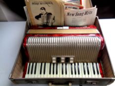 A Hohner Carena III piano accordion with accordion books,