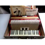 A Hohner Carena III piano accordion with accordion books,