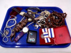 A tray containing assorted wristwatches, costume jewellery,