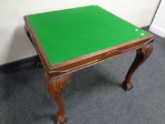 An Edwardian card table fitted with four card drawers on claw and ball feet