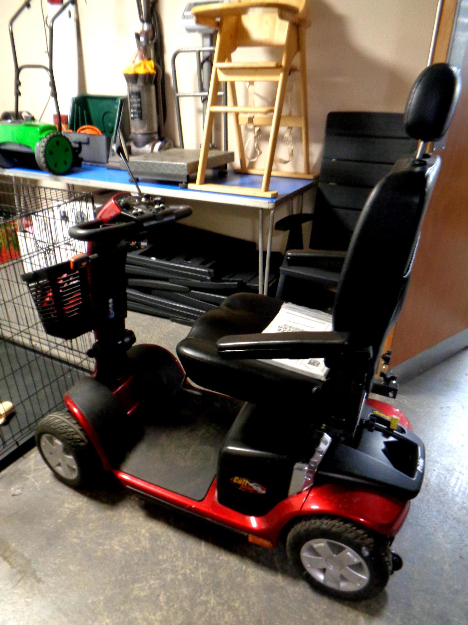 A Pride mobility cart with key and charger,