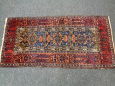 An Afghan rug of geometric design,