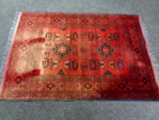 An Afghan rug (faded),