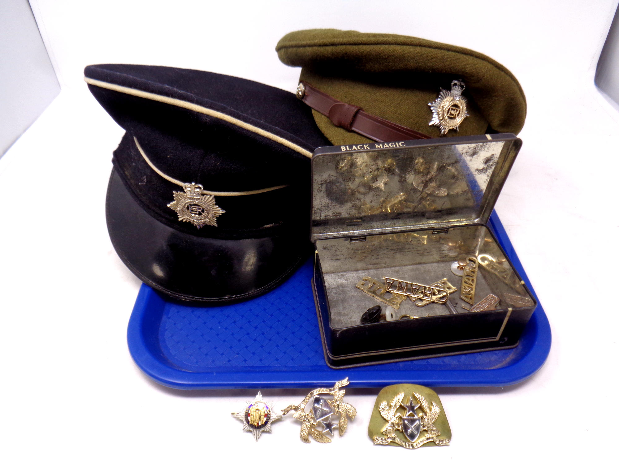 A cap bearing a Royal Corps of Transport badge together with a further cap bearing an Army Service