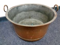 A 19th century copper twin handled cooking pot,