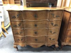 A 19th century oak serpentine fronted four drawer chest on cabriole legs,