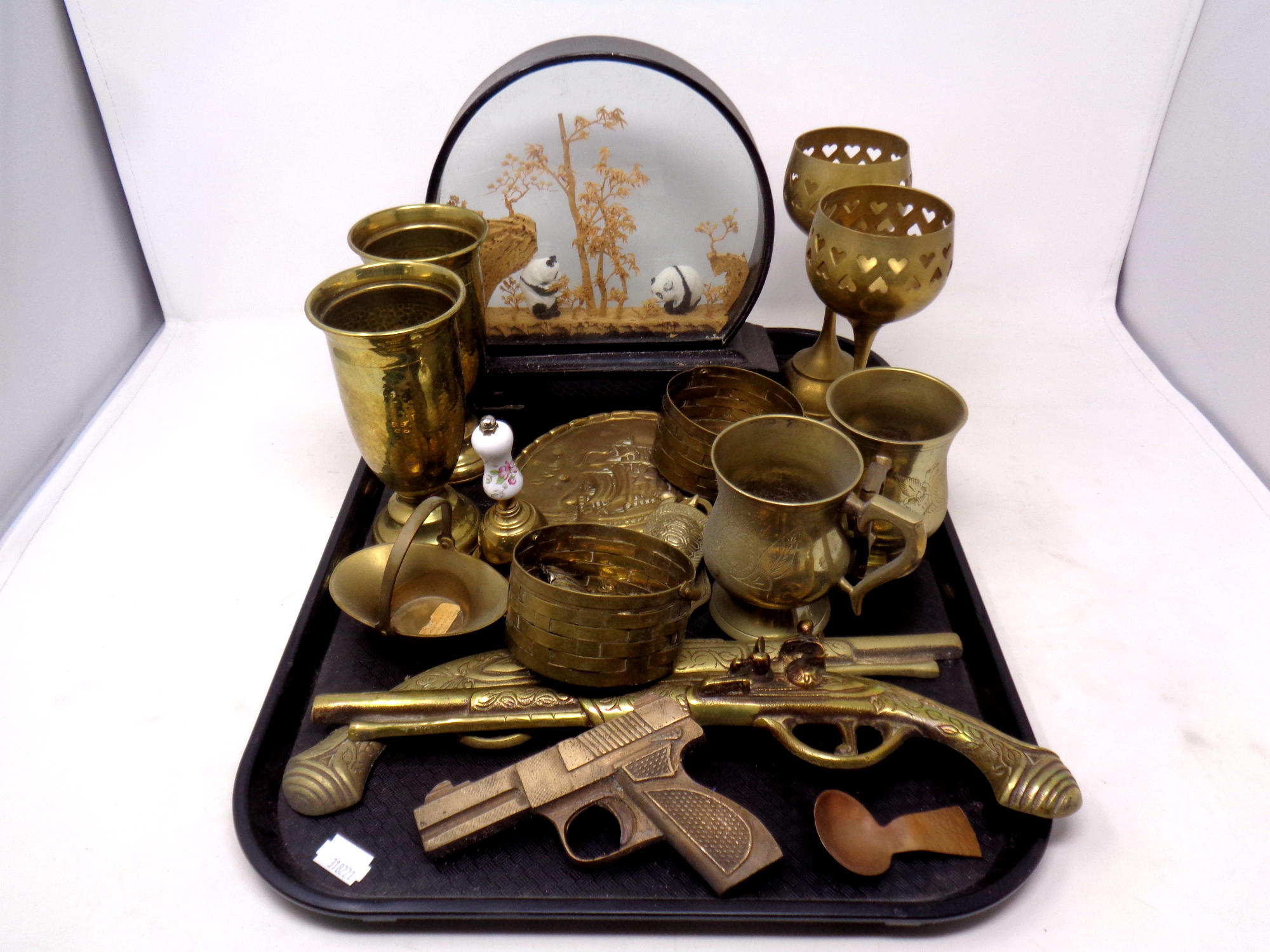 A tray containing assorted brass ware to include ornamental pistols, vases, tankards, plaque,