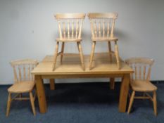 An oak dining table together with a set of four pine railback chairs
