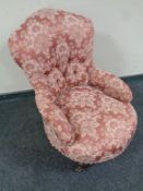A Victorian lady's chair upholstered in a pink floral fabric