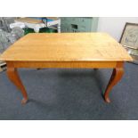 A 20th century continental dining table on cabriole legs