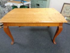 A 20th century continental dining table on cabriole legs