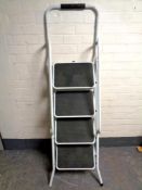 A four tread folding stepladder with handrail