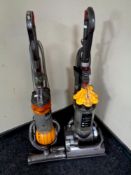 A Dyson DC 33 upright vacuum together with a further Dyson DC 25 ball vacuum