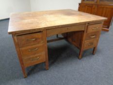 An Edwardian oak twin pedestal partner's desk