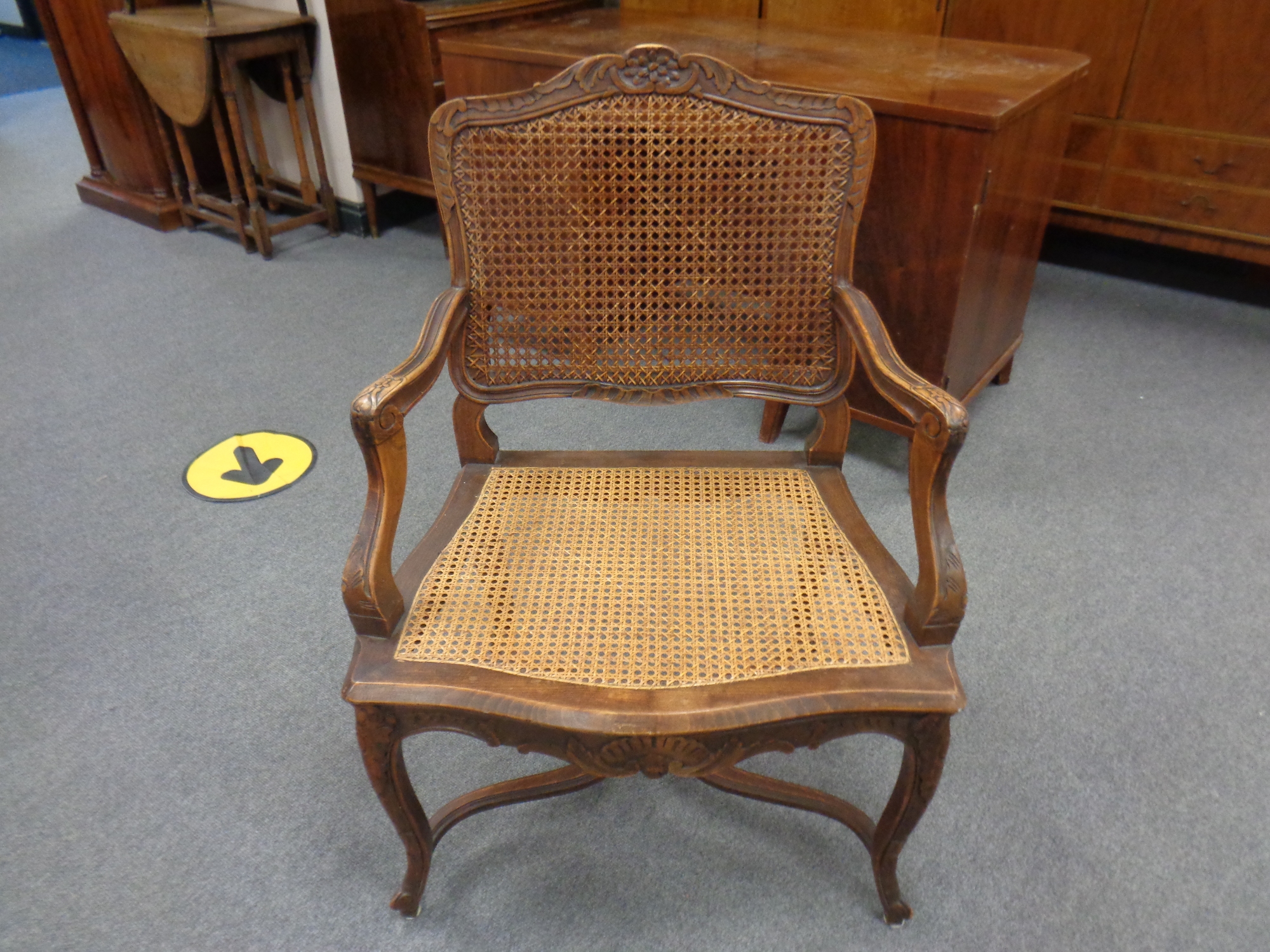 A carved beech French style salon armchair