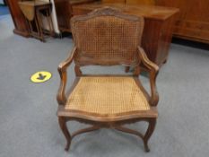 A carved beech French style salon armchair