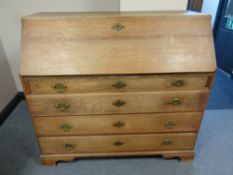 A 19th century oak fall front writing bureau fitted four drawers beneath,
