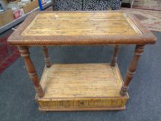 A bamboo and wicker two tier serving table fitted a drawer