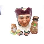 A large Royal Doulton character jug, Simon Cellarer, together with two tiny character jugs,