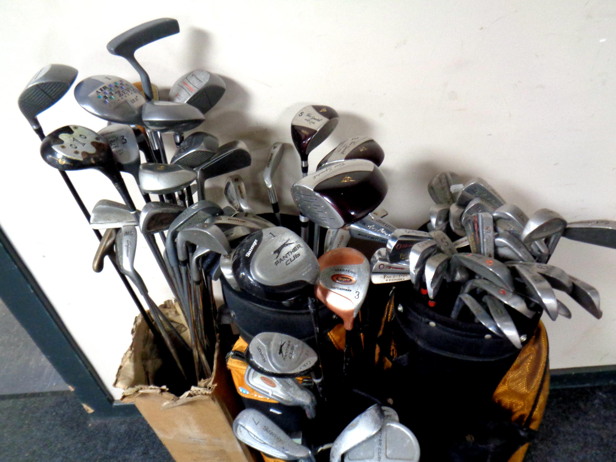 Three golf bags and a box containing a large quantity of assorted drivers, - Image 2 of 2