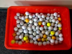 A box containing a large quantity of golf balls