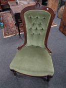 A 19th century mahogany framed lady's chair upholstered in a green button dralon