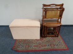 An upholstered blanket box together with a woolen rug,