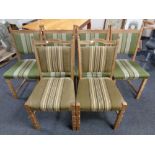 A set of four blonde oak dining chairs upholstered in a green striped fabric together with a
