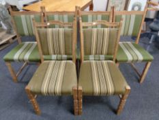 A set of four blonde oak dining chairs upholstered in a green striped fabric together with a