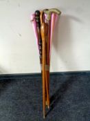 A bundle of walking sticks together with a wall fan