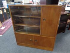 A set of mid 20th century sliding glass door bookshelves fitted three cupboards