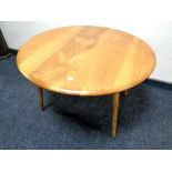 An Ercol elm coffee table on later legs
