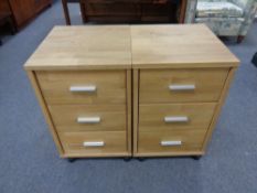 A pair of contemporary three drawer chests on casters