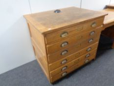 A 20th century oak six drawer plan chest