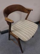 A mid 20th century teak elbow chair