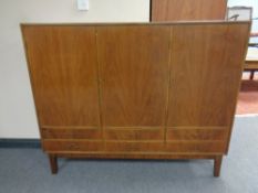 A mid 20th century continental triple door sideboard fitted six drawers beneath on raised legs,