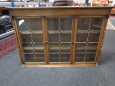 An oak triple leaded glass door dresser top