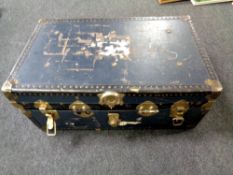 An early 20th century metal bound trunk containing assorted lady's clothing,