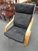 A beech framed armchair with matching footstool,