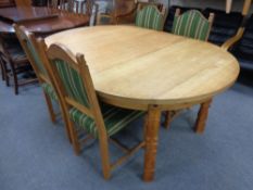 A continental blonde oak circular extending dining table with leaf, length 170 cm,