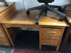 A 20th century oak single pedestal desk fitted three drawers and a slide