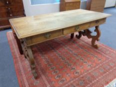 A continental oak library table fitted three drawers,