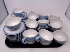 A tray containing eighteen Denby Colonial Blue teacups and saucers