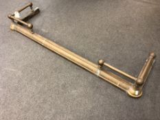 An adjustable brass fire curb with gallery rails at corners