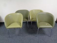 Two pairs of reception armchairs upholstered in a faux green leather on metal legs