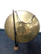 An eastern brass dinner gong with beater,